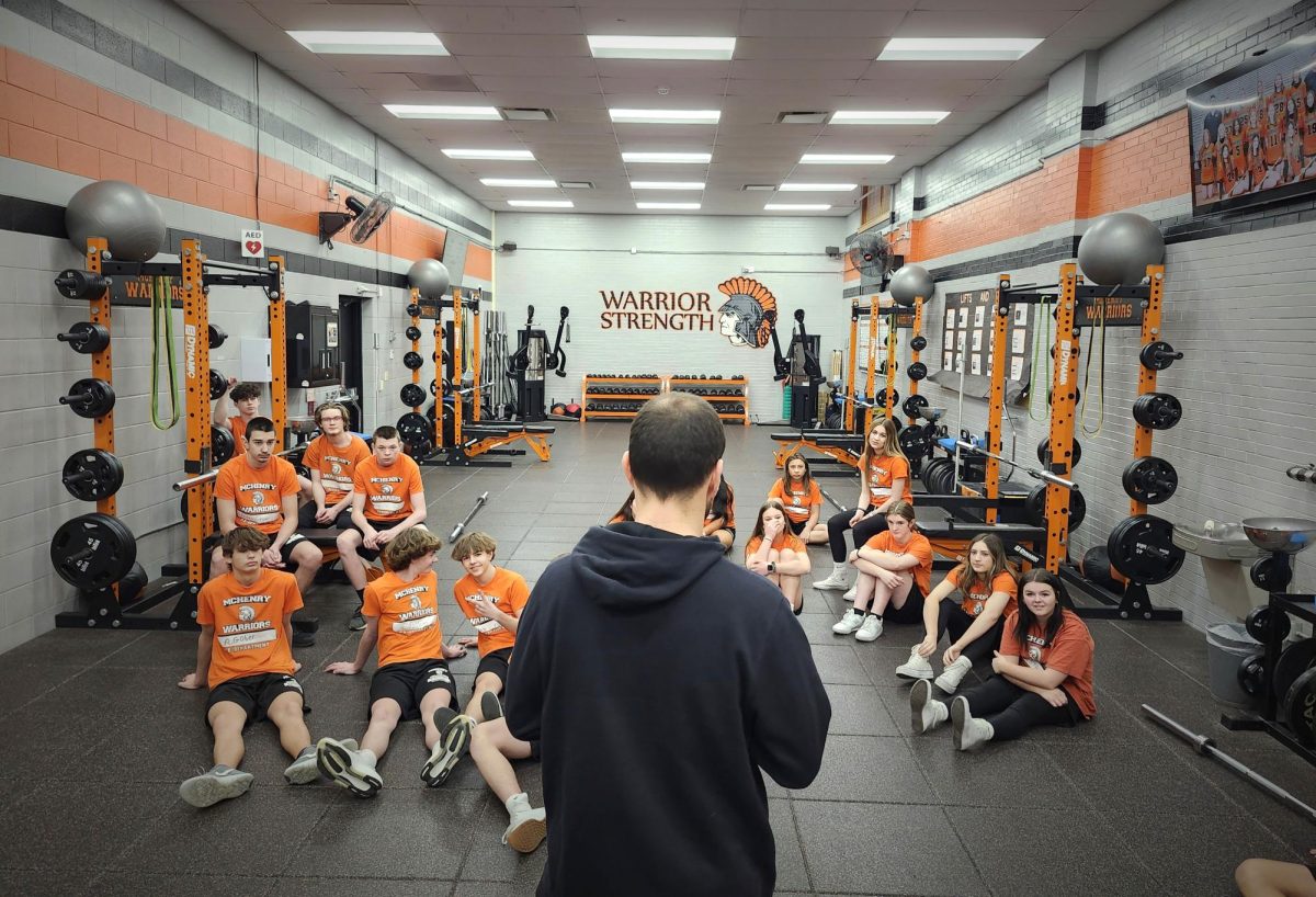 PE+teacher+Tony+Swanson+addresses+his+Strength+class+in+the+weight+room+at+the+Freshman+Campus.+His+research+shows+that+kids+perform+better+in+fitness+testing+when+they+engage+in+strength+training.