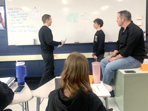 Maxwell Zerdt give feedback to a student from during tutorials AVID 9 class on April 4 at the Freshman Campus. Tutor Chad Dunn helped assist the other students as they asked questions and tried to solve the problem.