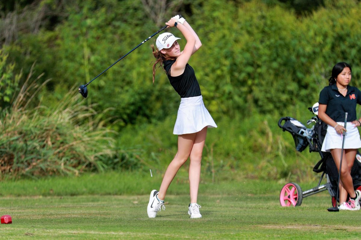 Varsity girls golfer Kilynn Axelson swings her club during a meet on August 20 at Boone Creek Golf Club in Bull Valley.