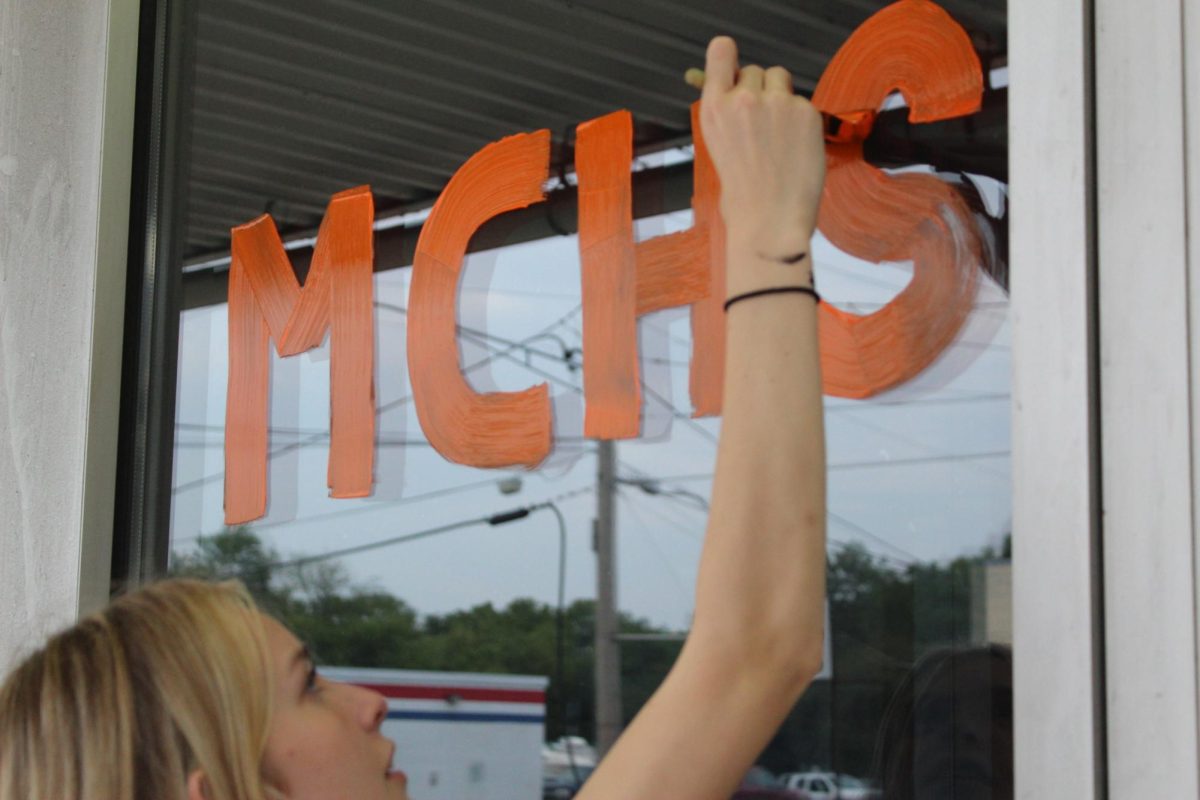 Band students paint windows during Paint the Town in preparation for Homecoming last September.