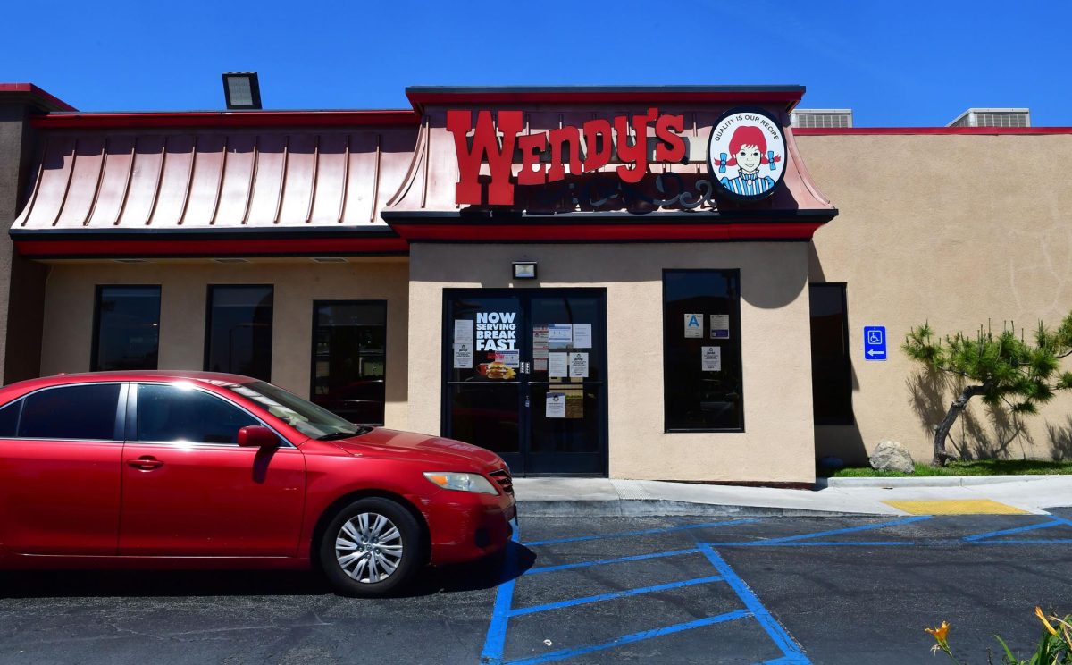 A vehicle pulls into the drive-thru lane at a Wendy's fast food restaurant in Alhambra, California on May 5, 2020. 