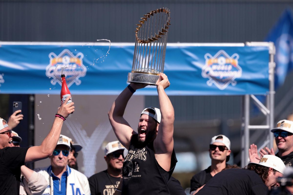 Los Angeles Dodgers pitcher Clayton Kershaw holds the World Series trophy aloft after speaking at the ceremony at Dodger Stadium amid the celebration of the Dodgers' World Series title, in Los Angeles on Friday, Nov. 1, 2024.
