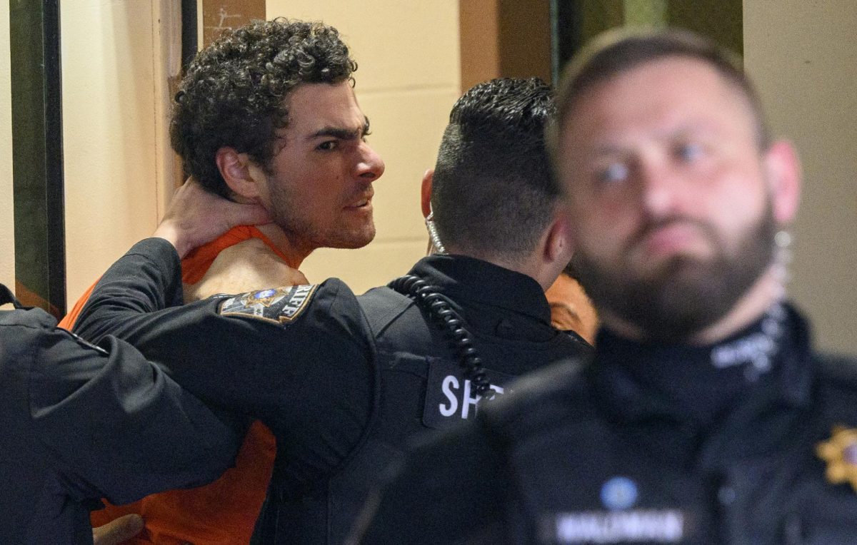 Suspected shooter Luigi Mangione is led into the Blair County Courthouse for an extradition hearing Dec. 10, 2024, in Hollidaysburg, Pennsylvania. Mangione has been arraigned on weapons and false identification charges related to the fatal shooting of United Healthcare CEO Brian Thompson in New York City. Mangione is incarcerated in the State Correctional Institution in Huntingdon, Pennsylvania awaiting extradition to New York. 