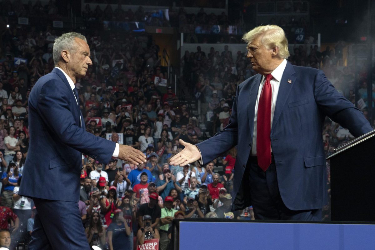 Former Republican presidential candidate Robert F. Kennedy Jr. and Republican presidential nominee former U.S. President Donald Trump shake hands during a campaign rally at Desert Diamond Arena on Aug. 23, 2024, in Glendale, Arizona.