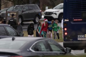 Children are escorted from a church next to the Abundant Life Christian School on Dec. 16, 2024, in Madison, Wisconsin. According to reports, a student and teacher were shot and killed at the school earlier today, and the suspected shooter was found dead at the scene.