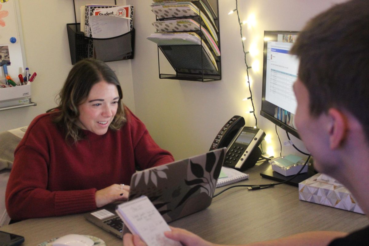 Counselor Kate Schak meets with a student about his schedule in her office at the College and Career Center at the Upper Campus during the first week back after winter break.