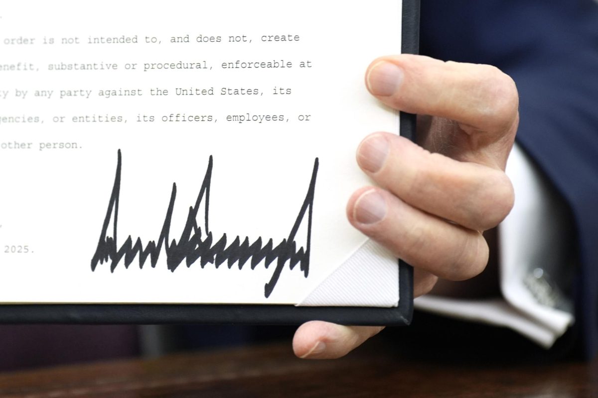 U.S. President Donald Trump signs executive orders in the Oval Office of the White House in Washington, D.C., on Jan. 23, 2025.