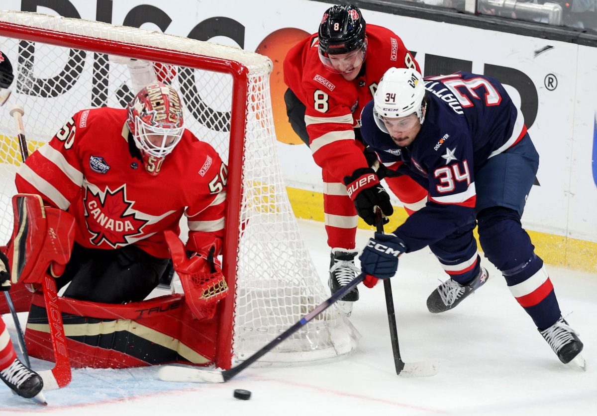 Team USA's Auston Matthews (34) tries to put the puck in past Canada's Cale Makar (8) and goaltender Jordan Binnington (50) during the first period of the NHL 4 Nations Face-Off Championship Game at TD Garden on Thursday, Feb. 20, 2025, in Boston. 