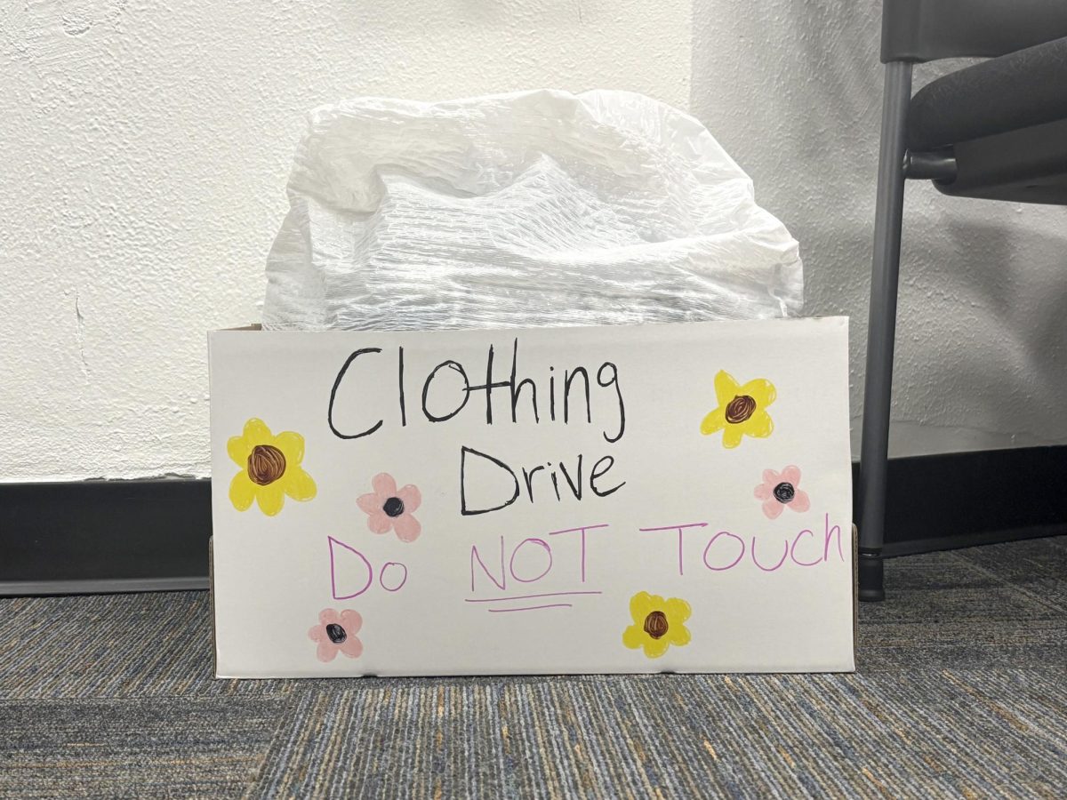 A box of clothes for the AVID clothing drive sits in the Freshman Campus main office earlier this week. The clothes will be donated to local organization that supports moms.