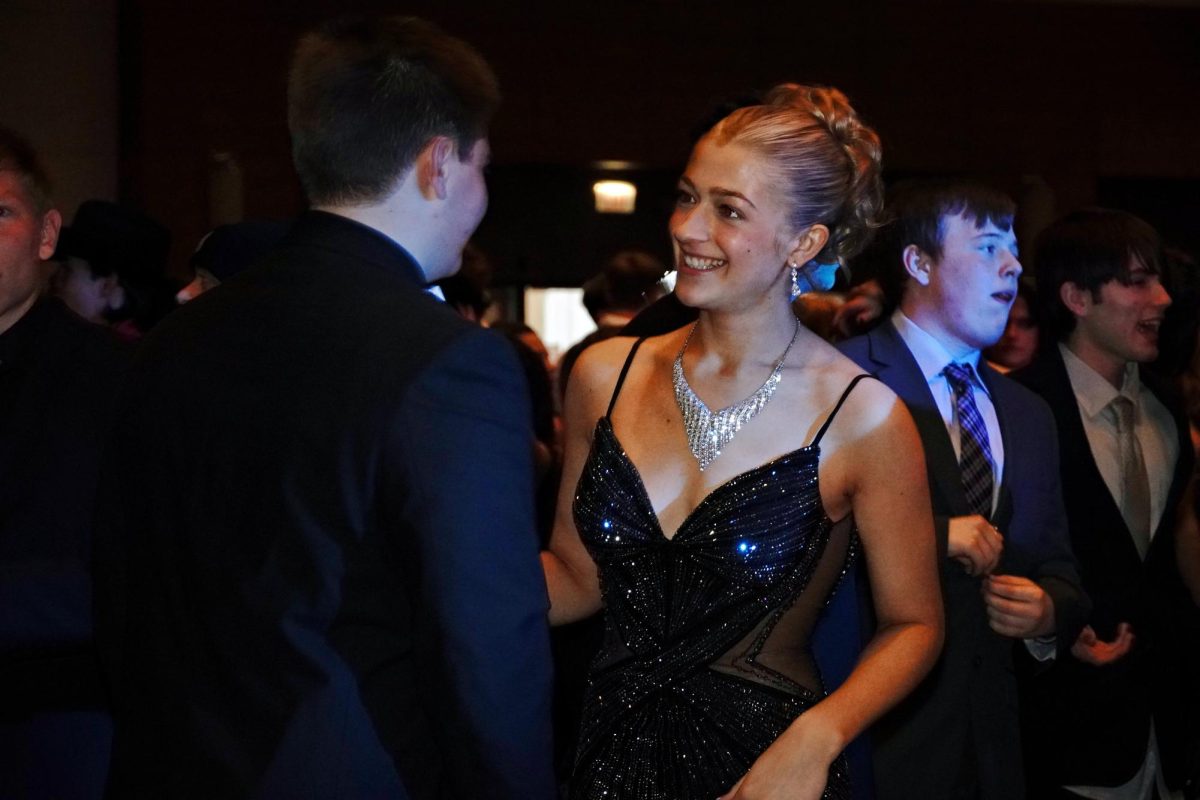 Students meet on the dance floor during last year’s prom before dancing the rest of the night away. Though some say prom’s tickets are too much money for many students, plenty of students spend twice as much on dresses and tuxedoes, hair, make-up, accessories, transportation and more on the event.