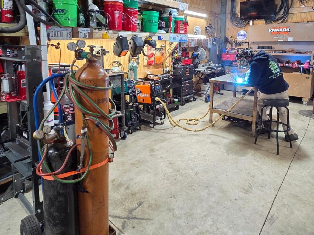 Evan Ewertowski welds in his garage as part of his own custom fabrication and land clearing company Boone Creek Welding.