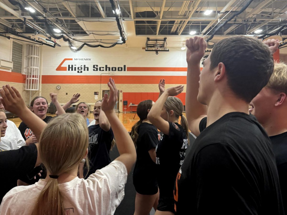 The girls and boys on MCHS’s varsity cheer team come together at the end of practice on Nov. 14 in the Freshman Campus Upper Gym.