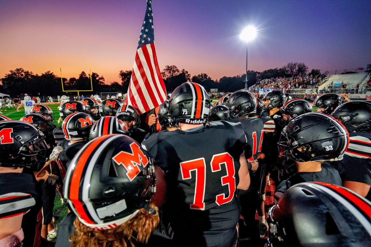 The McHenry Warriors varisty football team meets in the end zone at McCracken Field before the Homecoming football game on Oct. 3.