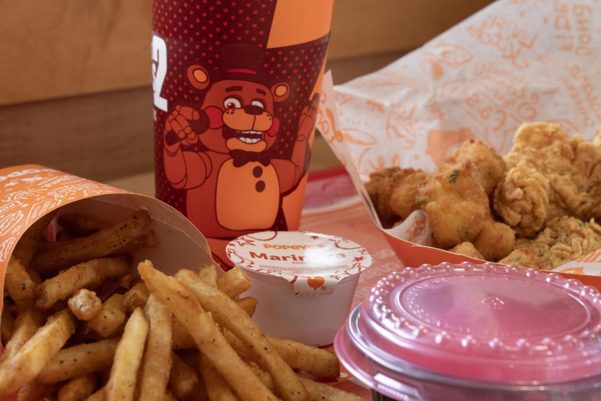 Popeyes's Freddy Fazbear Box, which promotes the "Five Nights at Freddy's 2" in theaters now, features three chicken tenders topped with garlic parmesan rub and is served with warm garlic-crusted Cheesy Bites and a marinara sauce.