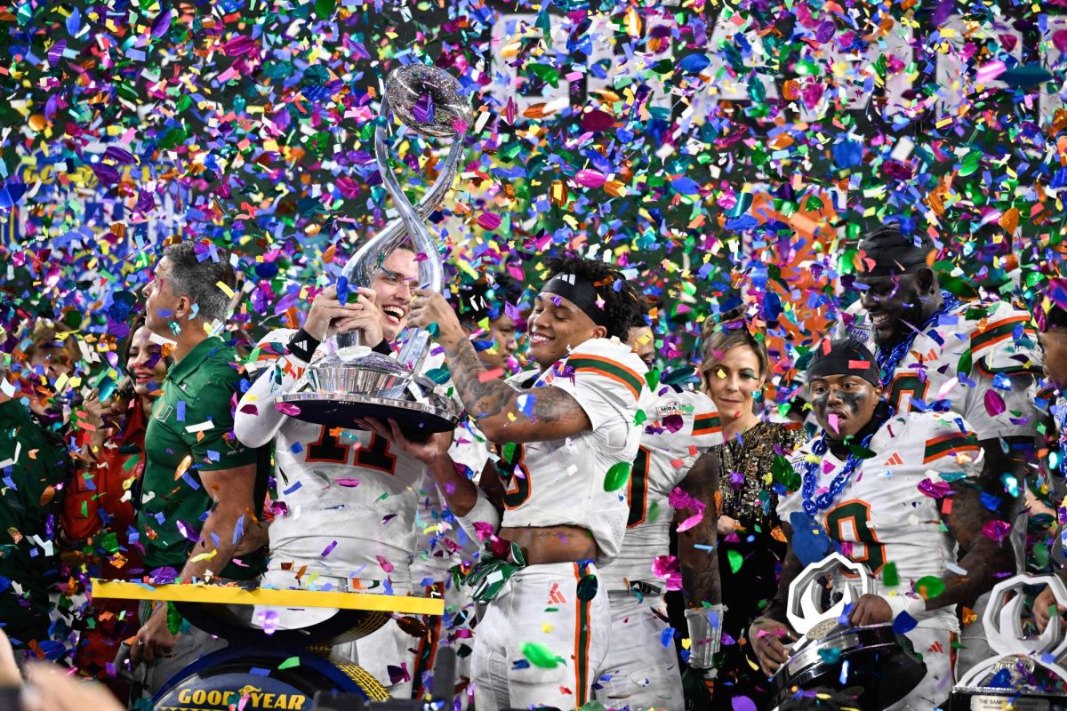 Miami Hurricanes quarterback Carson Beck (11) and Miami Hurricanes defensive back Jakobe Thomas (8) lift the Cotton Bowl trophy after defeating the Ohio State Buckeyes during the 2025 Cotton Bowl and quarterfinal game of the College Football Playoff at AT&T Stadium. Players on the Hurricanes are included in those impacted by the NCAA’s transfer portal. 