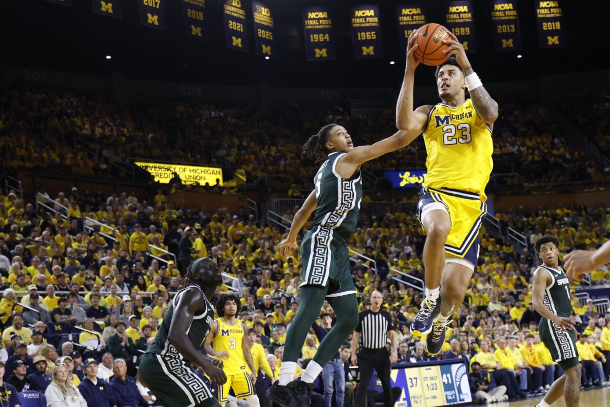 Mar 8, 2026; Ann Arbor, Michigan, USA;  Michigan Wolverines forward Yaxel Lendeborg (23) shoots on Michigan State Spartans forward Jordan Scott (6) in the first half at Crisler Center. Mandatory Credit: Rick Osentoski-Imagn Images