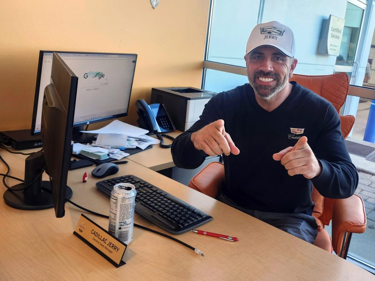 "Cadillac" Jerry Spanier sits at his desk at the Castle dealership on Route 31. Cadillac Jerry visits basketball games around McHenry County and films TikToks.