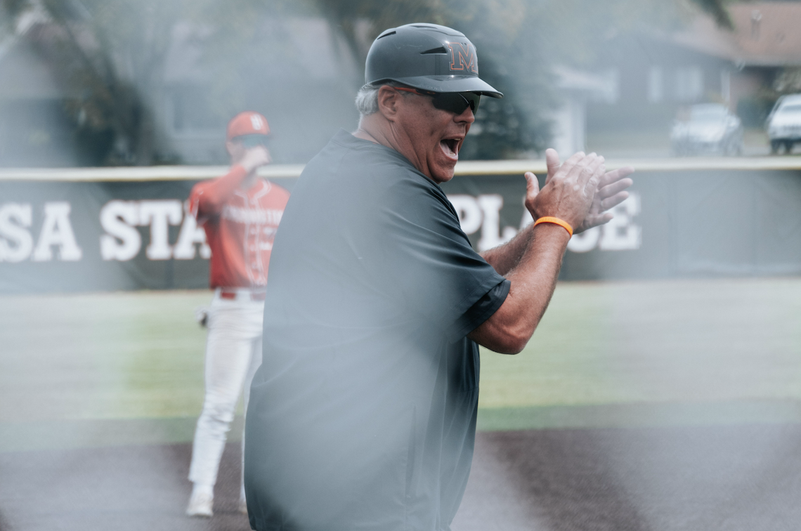 Coach Brian Rockweiler cheering on the MCHS Baseball team during the IHSA 4A Regional Championship.