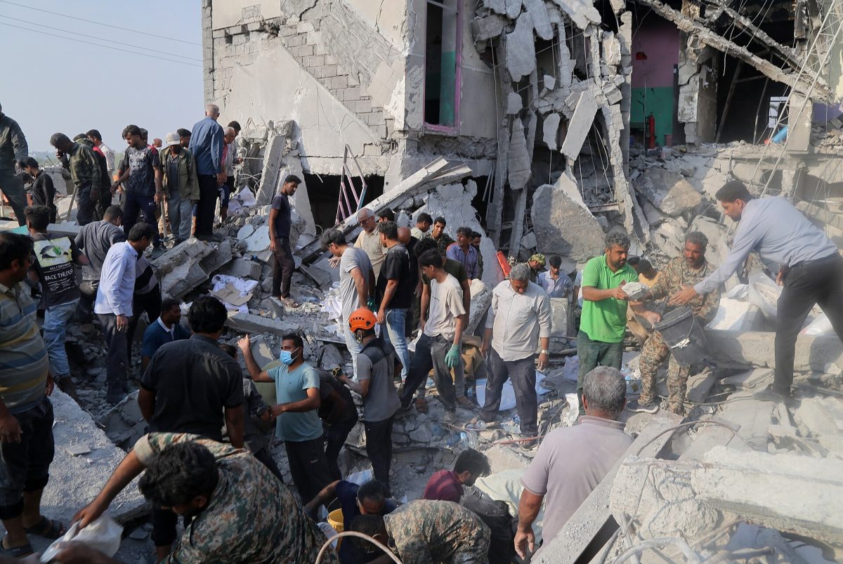 Iranians dig out of the rubble after the Shajareh Tayyebeh Cchool in  in Minab, Hormozgan province in southern Iran was destroyed by a missile strike on Feb. 28. This attack is further evidence that the U.S. is no longer the world's moral power.