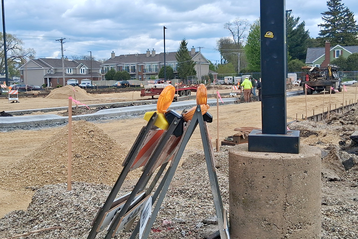 Construction workers inspect the curbs in the Freshman Campus parking lot on April 29. Until the parking lot has been completed, parents will continue to pick-up students along an alternate route.