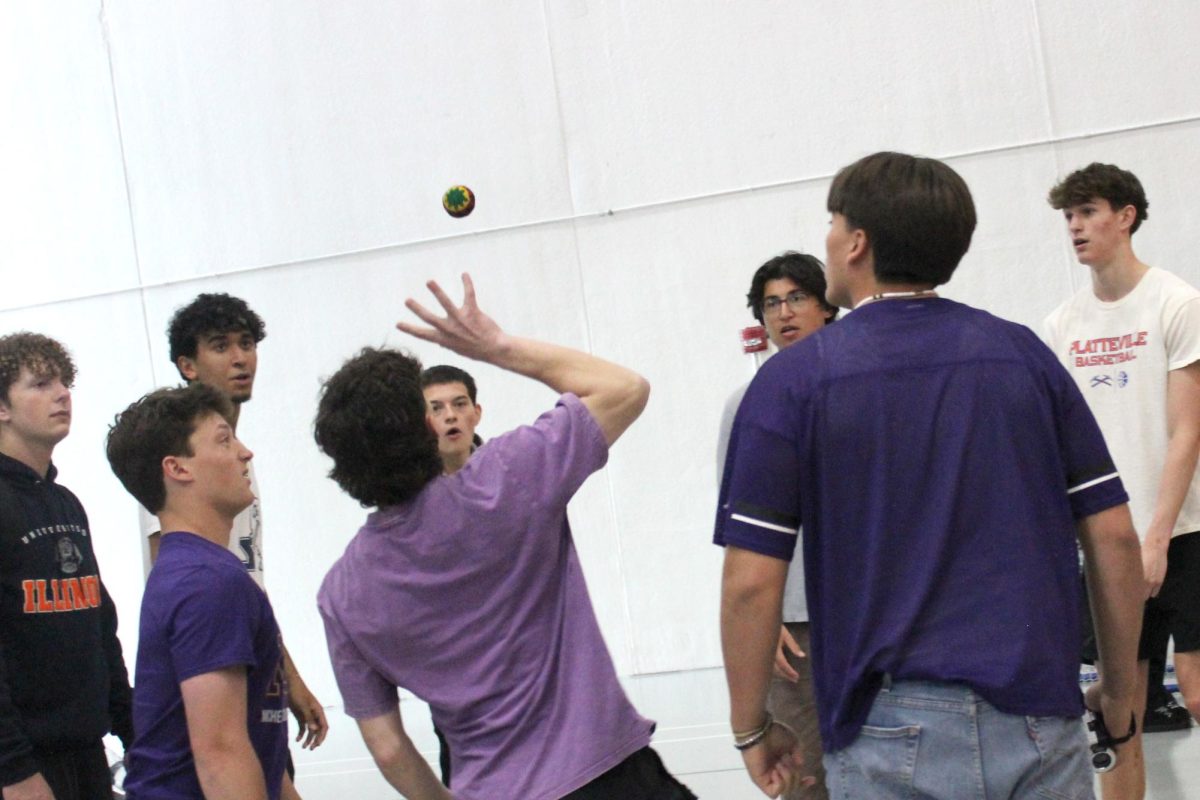 Students play hacky sack after senior decision day  in the Upper Campus main gym on May 1. More and more students have taken to the halls in the past month to play a game that most teachers played when they were in high school.