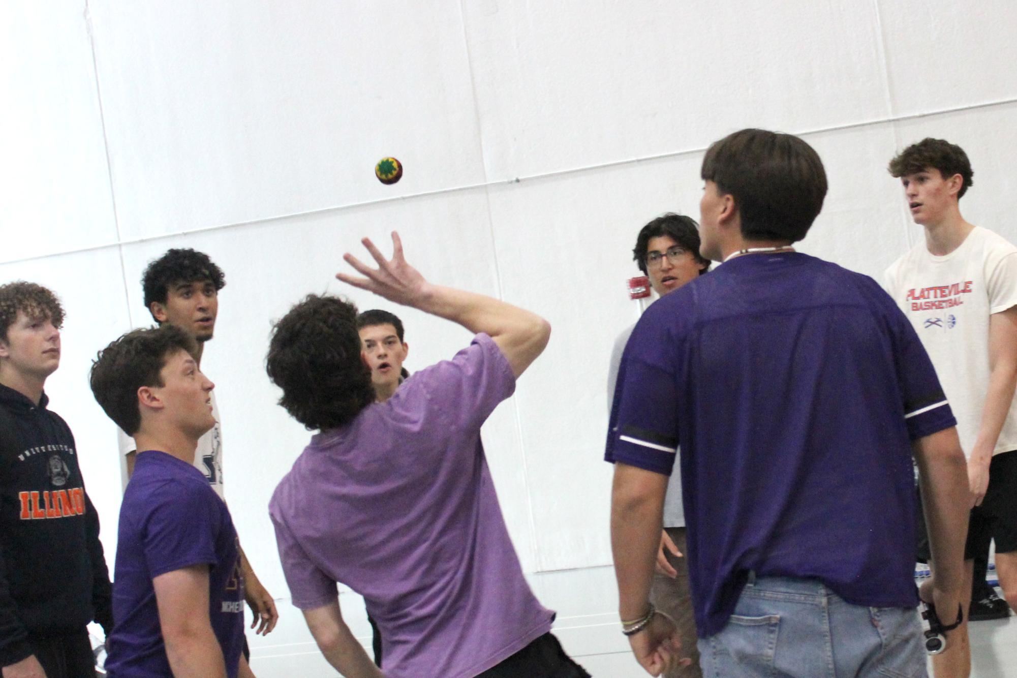 Students play hacky sack after senior decision day  in the Upper Campus main gym on May 1. More and more students have taken to the halls in the past month to play a game that most teachers played when they were in high school.